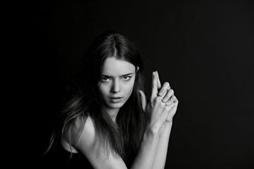 Fototapeta premium Beautiful long haired girl. The gesture of fingers the gun