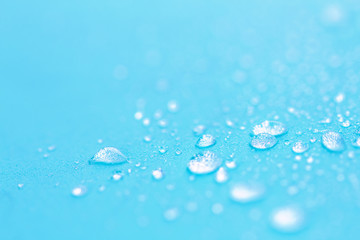 Close up rain water drops on blue sponge surface as abstract bac