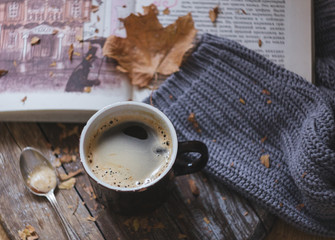 morning coffee with a book in a pleasant autumn atmosphere with a warm sweater and a book