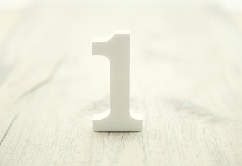 Number one on rustic wooden background. Top concept. 