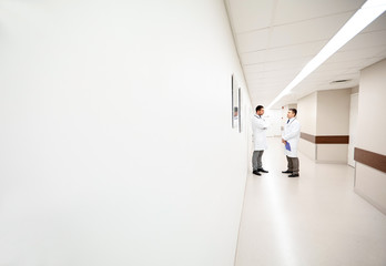 male doctors talking at hospital corridor