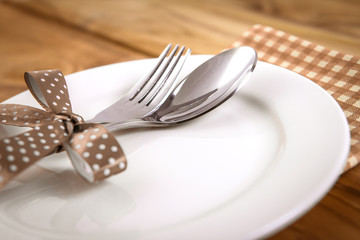 close up dinner setting fork and spoon on plate 