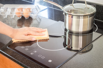 Hand cleaning cooker at home kitchen