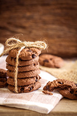 Close up stacked chocolate chip cookies on  napkin 