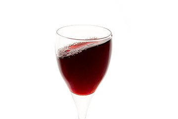 a glass of red wine on white background, isolated in backlight