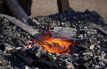 The heating of metal billets on hot coals