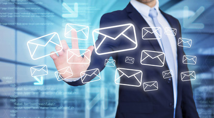 Businessman touching technology interface with email icons