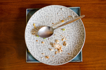 .Empty plates and spoons are placed on the Ta after the meal is