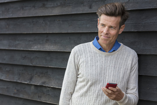 Happy Middle Aged Man Using Mobile Cell Phone