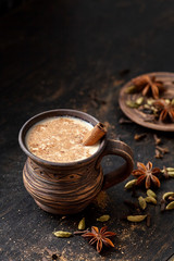 Milk tea chai latte traditional tasty refreshing morning breakfast sweet organic healthy hot beverage drink with natural aroma spices blend, cardamon, anise, cinnamon, in rustic ceramic cup