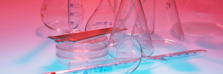 Laboratory equipment against red background on blue table