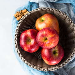 Fresh apples in basket on napkins. Square