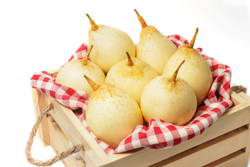 Fresh chinese pears on wooden crate on white