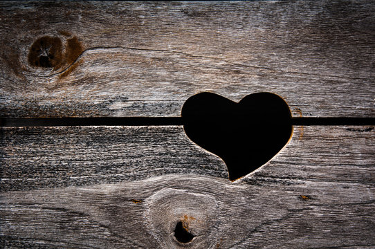 Heart shaped cut out of planks in a wooden fence