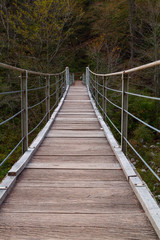Wooden bridge the turquoise green Soca river in Slovenia