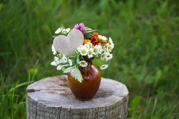 Yellow Marigolds. Tagetes erecta flowers and daisies with wooden decorative heart