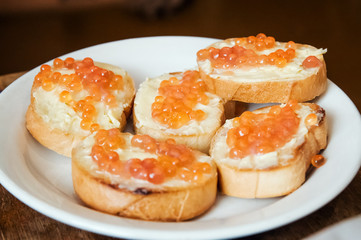sandwiches with red caviar on a plate