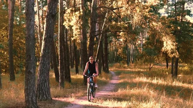 Mountain biking - man with bike enjoy summer vacation. slow motion