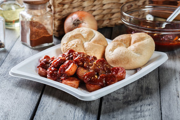 Delicious German currywurst - pieces of sausage with curry sauce