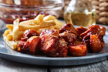 Traditional German currywurst - pieces of sausage with curry sauce