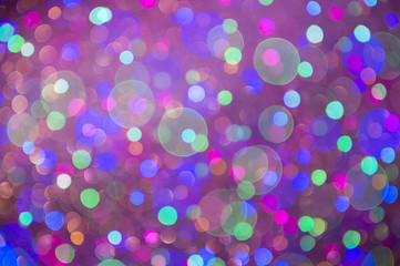 Holiday background in an abstract defocus in vibrant magenta pink bokeh with spots of other colors