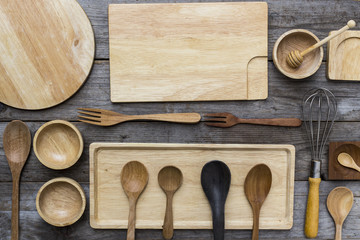 various kitchen utensils on wooden table background