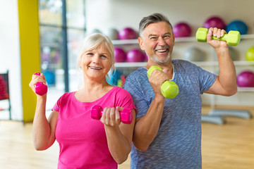 Senior couple exercising in gym
