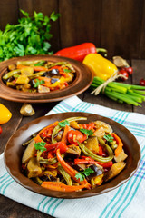 Vegetable stew (salad): bell pepper, eggplant, asparagus beans, garlic, carrot, leek. Bright spicy aromatic dishes. Menu of Italian cuisine.