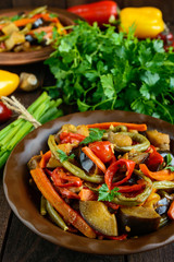 Vegetable stew (salad): bell pepper, eggplant, asparagus beans, garlic, carrot, leek. Bright spicy aromatic dishes. Menu of Italian cuisine.