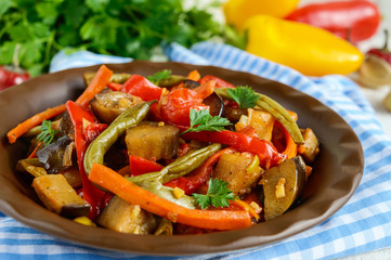 Vegetable stew (salad): bell pepper, eggplant, asparagus beans, garlic, carrot, leek. Bright spicy aromatic dishes. Menu of Italian cuisine.