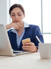 Businesswoman reading sms