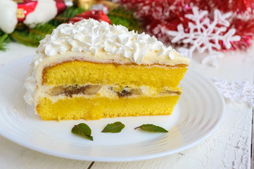 A large piece of delicate sponge cake decorating air cream. Festive dessert on a white background. To celebrate Christmas, New Year's Eve. Close up