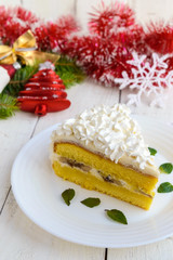 A large piece of delicate sponge cake decorating air cream. Festive dessert on a white background. To celebrate Christmas, New Year's Eve.