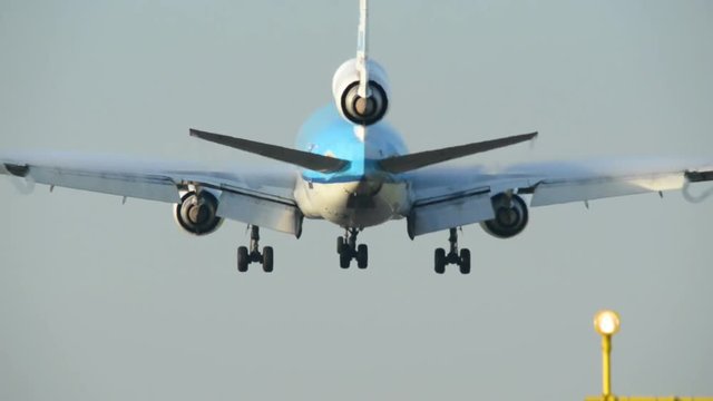 Three Engine Airplane Landing Very Close Backview  - No Visible Signs Or Numbers
11009