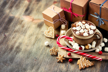 Hot cacao drink with marshmallows, gift box and christmas cookie