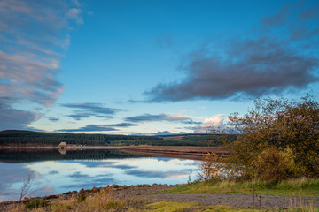 Obraz premium Still Water at Kielder Dam, in Kielder Water and Forest Park, Northumberland, which has the largest man made lake in Northern Europe. The reservoir sits in the North Tyne Valley