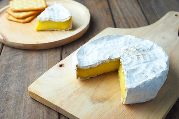 Close up of camembert cheese on a wooden board.