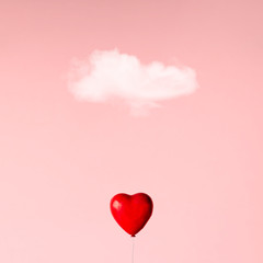 Ballon in heart shape on pink sky. Love concept.
