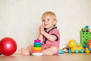 Year-old child playing with educational cup toys at home