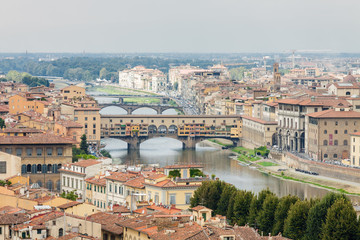 Fototapeta na wymiar Cloudy view to the river Arno, with Ponte Vecchio, Palazzo Vecchio and Cathedral of Santa Maria del Fiore (Duomo), Florence, Italy