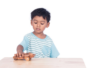 cute child asian boy playing wooden plane