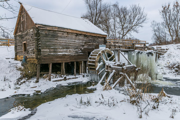Old watermill in Krasnikovo, Kursk region. Winter, watermill is frozen in ice