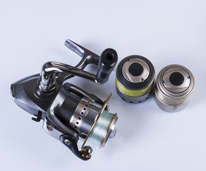 spool of fishing line, floats and a box of hooks