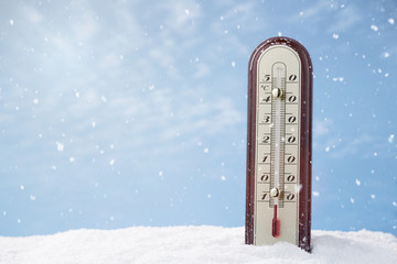 Close up of a thermometer in the snow with copy space