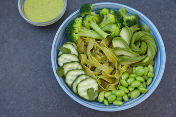 Vegetarian pasta with cucumber, broccoli, avocado and edamame