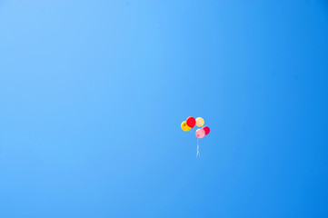 The colored balls into the blue sky