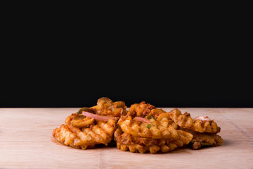 Waffle fries topped with onions and beef