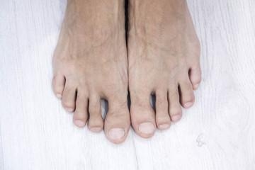 top view of Male nail and feet on white background,This has a clipping path