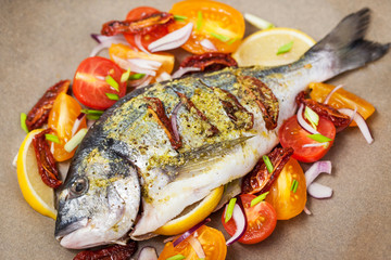 Raw whole sea bream fish and vegetables ingredients