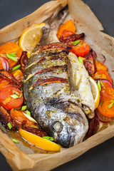 Oven baked whole sea bream fish  with vegetables